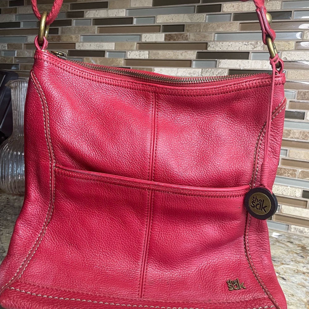 The Sak Red Shoulder Bag with Pebbled Leather and Paneled Design